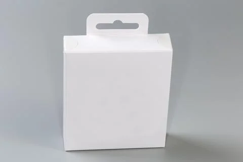 White rectangular cardboard hang tab packing box on gray surface Stock Photos