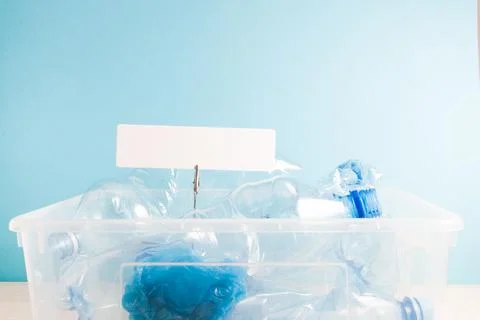 White rectangular cardboard label on a clothespin on a paper spring in a plas Stock Photos