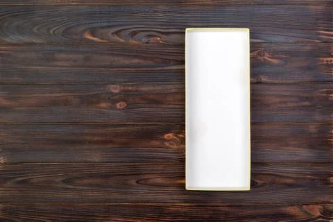White rectangular empty open box, top view on dark wooden background. top vie Stock Photos