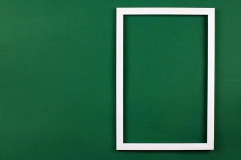 White rectangular frame on a green background. View from above. 스톡 사진