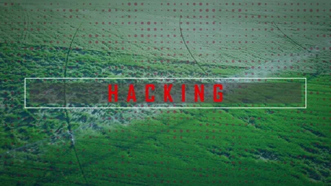 White rectangular overlay showing bold red HACKING text over aerial farmland, 動画素材 307431839