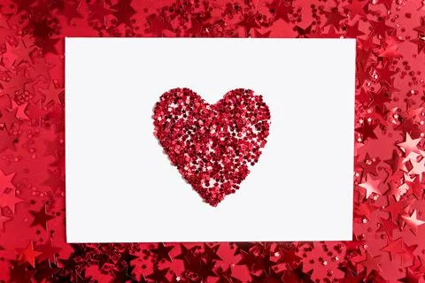 White rectangular paper with a heart in the middle on a red background with c Stock Photos
