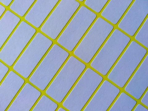 White rectangular price tag stickers on a bright yellow background sheet Stock Photos