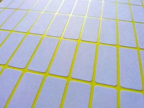 White rectangular price tag stickers on a bright yellow background sheet 写真素材