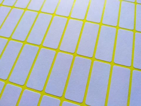 White rectangular price tag stickers on a bright yellow background sheet Stock Photos