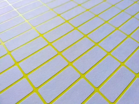 White rectangular price tag stickers on a bright yellow background sheet Stock Photos
