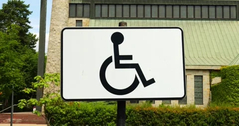 White rectangular sign displaying black international symbol of accessibility Stockbeeldmateriaal 317772853