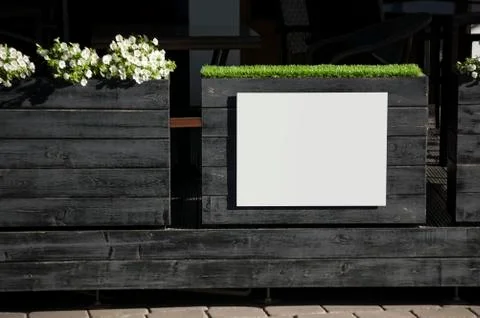 White rectangular signboard template on a black wood. Stock Photos