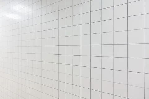 White rectangular tiles wall pattern surface texture. Close-up of interior de Stockfoto's
