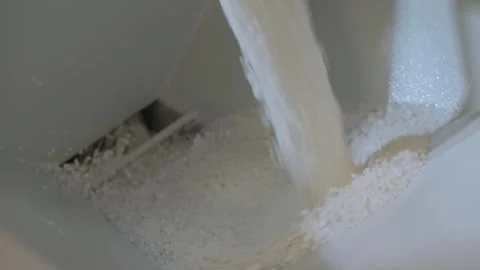 White recycled plastic granules, pellets falling into metal container Stock Footage 341314184