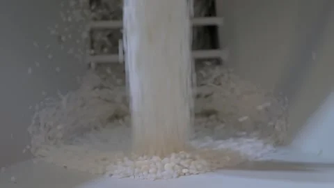 White recycled plastic granules, pellets falling into metal container: close up Stock Footage 341319257