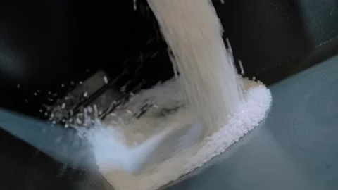 White recycled plastic granules, pellets falling into metal container Stock Footage 341850303