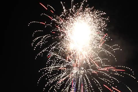 White red flashes rosette fireworks fireworks on a dark background holiday at Stock Photos