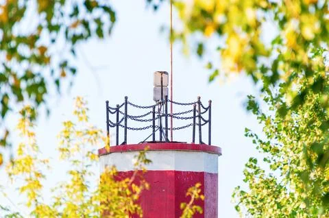White-Red Lighthouse Surrounded by Green and Yellow Deciduous Trees Stock Photos