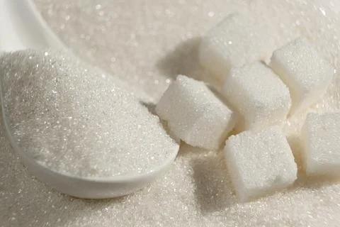 White refined beet sugar in the form of crystals and cubes. Stock Photos