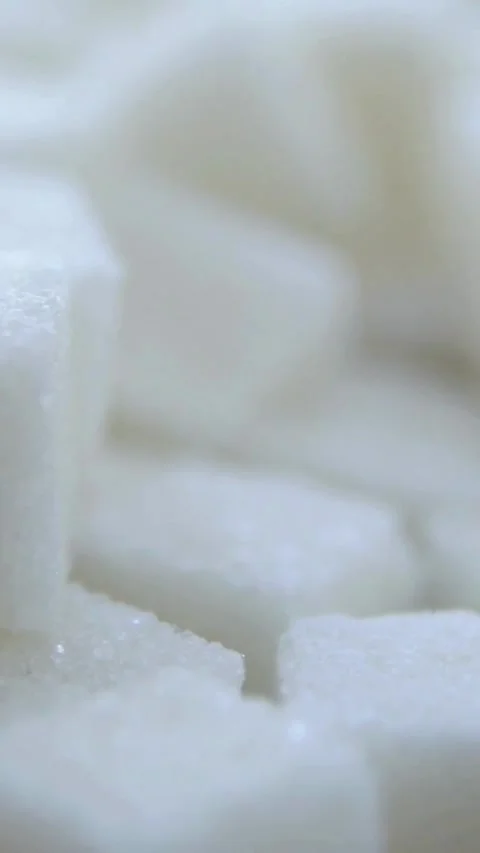 White refined sugar cubes piled together showing crystalline texture Video stock 334168749