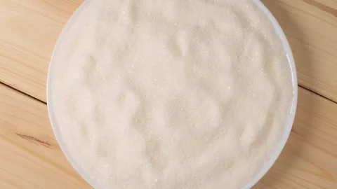 White refined sugar rotating in bowl Stock Footage 339367082