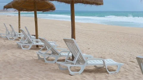 White relax chairs in beach close to ocean Video stock 107186959