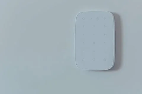 White remote control on light blue wall surface Stockfoto's