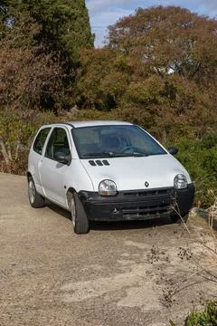 White Renault Twingo  Compact Car On A Country Road With Autumn Trees And C.. Stock Photos