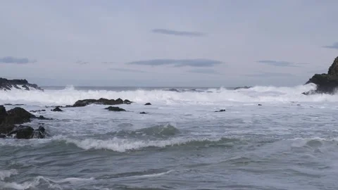 White rested waves rolling into shore at Dunseverick Northern Ireland Vídeos de archivo 303451236
