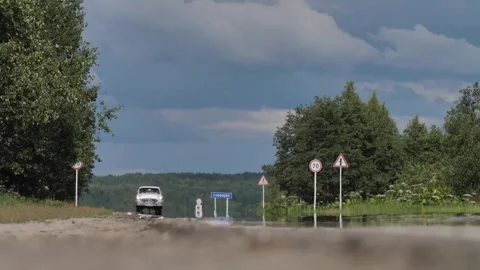 White Retro Car Appears over the Horizon on High Speed and Drive by Road Stock Footage 252596987