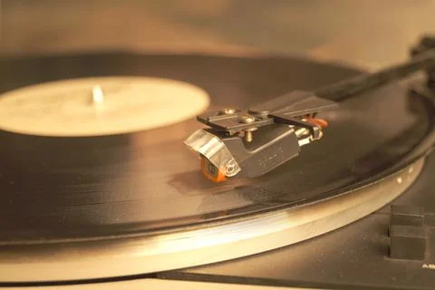 White retro record player on a gray table. Selective focus. Stock Photos