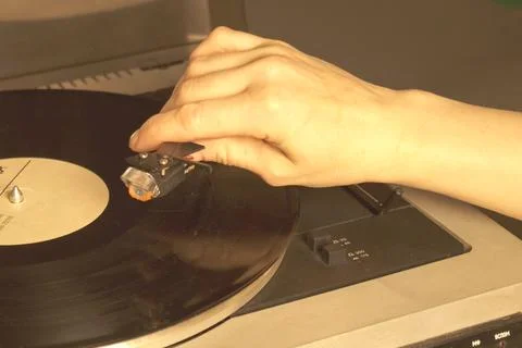 White retro record player on a gray table. Selective focus. Stock Photos