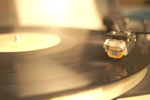 White retro record player on a gray table. Selective focus. Stock Photos