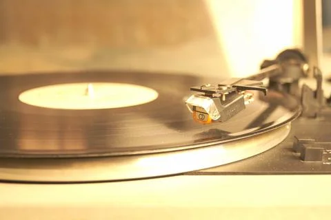 White retro record player on a gray table. Selective focus. Stock Photos