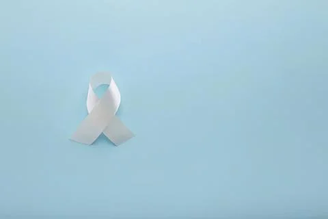 White ribbon loop on light blue background Фото