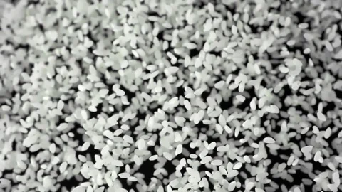 White rice flies after being exploded against black background. Shot with high Video stock 108458734