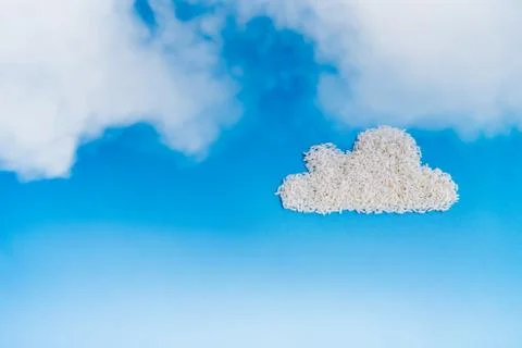White rice as fluffy cloud shape in the deep blue sky background, cloud stora Stock Photos