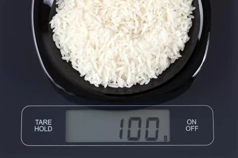 White rice on kitchen scale Stock Photos