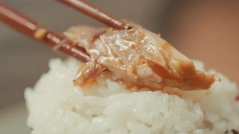 On white rice, put fish dishes with chopsticks. Korean food. Stock Footage 132376940