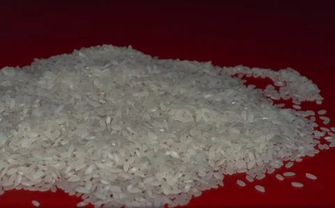 White rice on red  background  Stock Photos