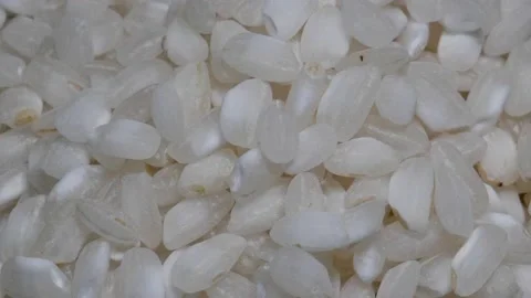 White rice on rotary base. Macro. Black background. Stock Footage 147151439