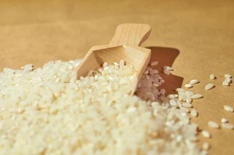 White rice is scattered on the table close up Stock Photos