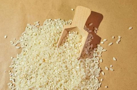 White rice is scattered on the table close up Stock Photos