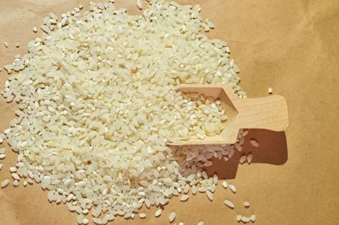 White rice is scattered on the table close up Stock Photos