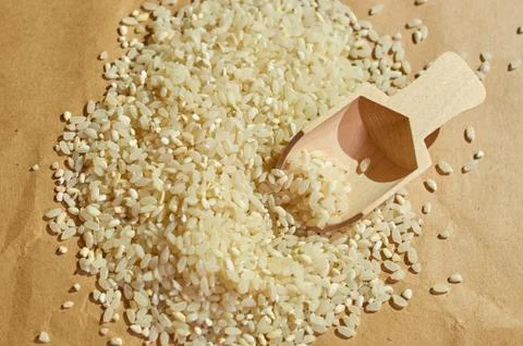 White rice is scattered on the table close up Stock Photos
