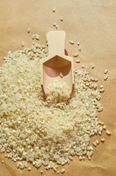 White rice is scattered on the table close up Stock Photos