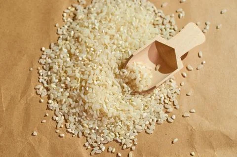 White rice is scattered on the table close up Stock Photos