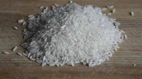 White rice seeds are falling on the cutting board Stock Footage 52076181