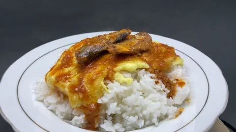 White rice with a side dish of egg and sardines wrapped in red chili Stock Footage 207787752