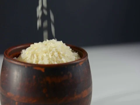 White rice spills out in a bowl of rice Stock Footage 120603353