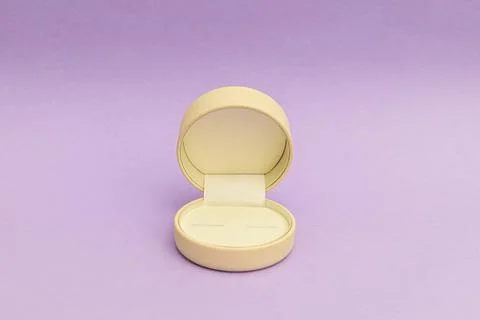 White ring box on a bright purple background Stock Photos