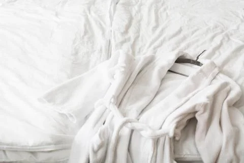 White robe for bath lying on bed 스톡 사진