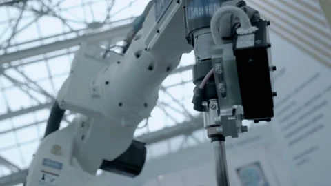 A white robot arm performs complex movements in the process of welding Stock Footage 167573962