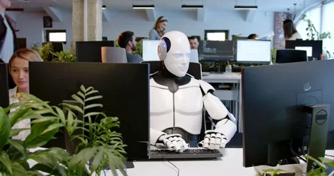 White robot sitting at table in office and typing on keyboard. Artificial Stock Footage 180023245